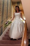 Bride descends stairs, heading to ceremony