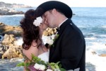 Bride and Groom Kiss on the rocky beach of the Monterey Bay