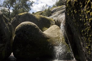 Curvy Rocks, falling water, moss, sky