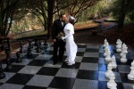 Bride and groom on giant chess board Chateau Du Sureau and Erna's Elderberry House wedding photos