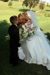 Ring bearer kisses bride wedding ceremony Summitpointe Golf Club in Milpitas