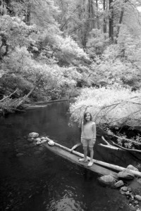 Delilah on log at river. Infrared photography of the Big Sur River on the summer solstice.