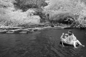 Children on tube. Infrared photography of the Big Sur River on the summer solstice.