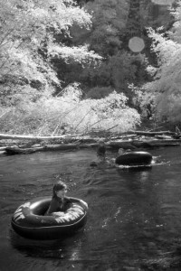 Kids floating on river. Infrared photography of the Big Sur River on the summer solstice.