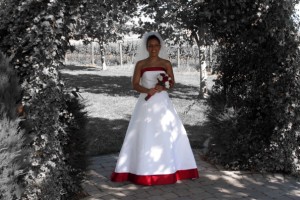 special effects photo of bride. Bride in color, background in black and white. white wedding dress with red trim.