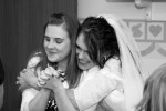 Bride hugs best friend black and white Christmas wedding calvary baptist church oroville, ca