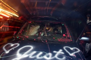 bride and groom drive away in decorated car, zoom explosion, Christmas wedding calvary baptist church oroville, ca