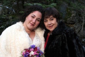 Bride and mom, both in fur. winter wedding in yosemite national park shot under bridal veil falls.