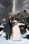 Bride and groom at the base of Bridal Veil Falls. winter wedding in yosemite national park shot under bridal veil falls.