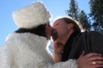 Bride and groom kiss. Bride in fur. Surounded by a halo of light. winter wedding in yosemite national park