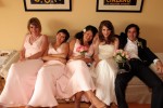 wedding party relaxes on couch at end or reception
