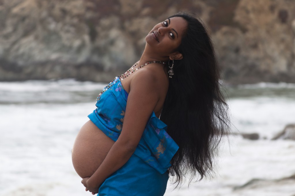 Pregnant Indian woman on beach